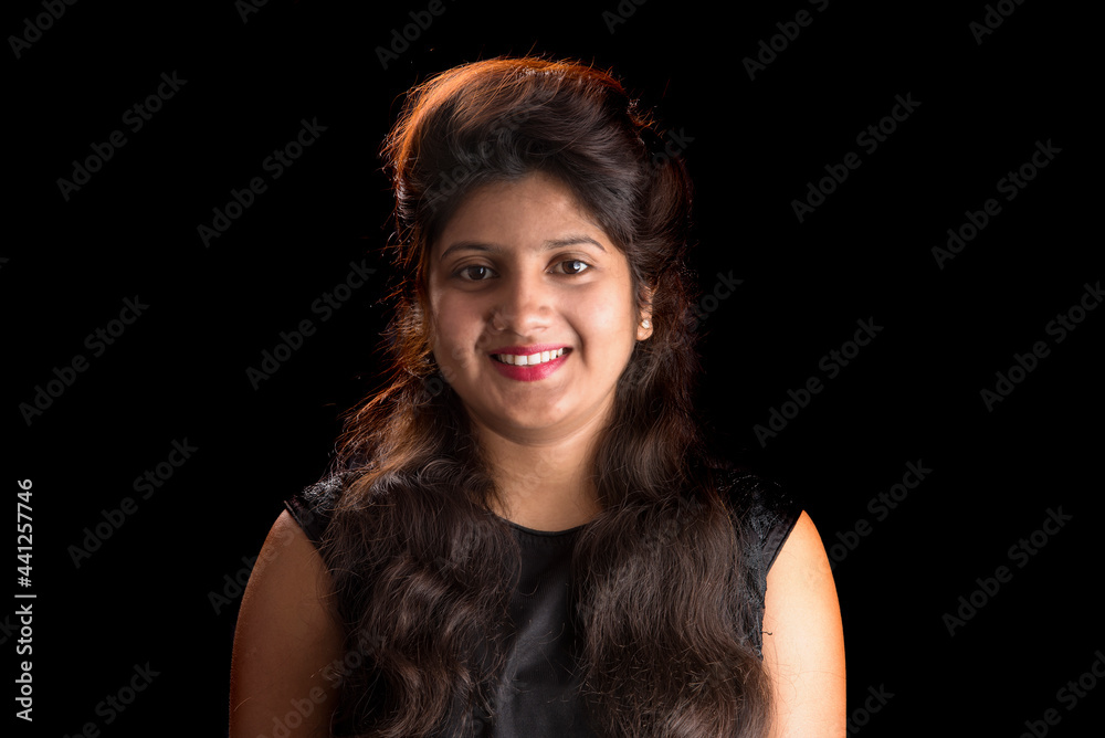 Fototapeta premium Portrait of beautiful young girl on black background