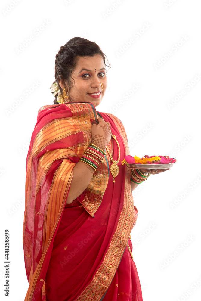 Portrait of a Indian Traditional Girl holding pooja thali with diya during festival of light on white background. Diwali or deepavali Portrait of a Indian Traditional Girl holding pooja thali with diya during festival of light on white background. Diwali or deepavali