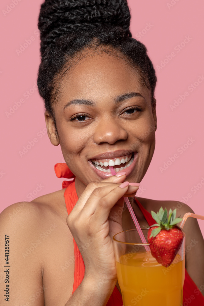 Young african american woman drinking a cocktail Young african american woman drinking a cocktail