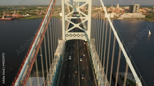 Aerial view Ben Franklin Bridge traffic with slow camera uptilt. Ben Franklin Bridge is a suspension bridge connecting Philadelphia and Camden, NJ. photo