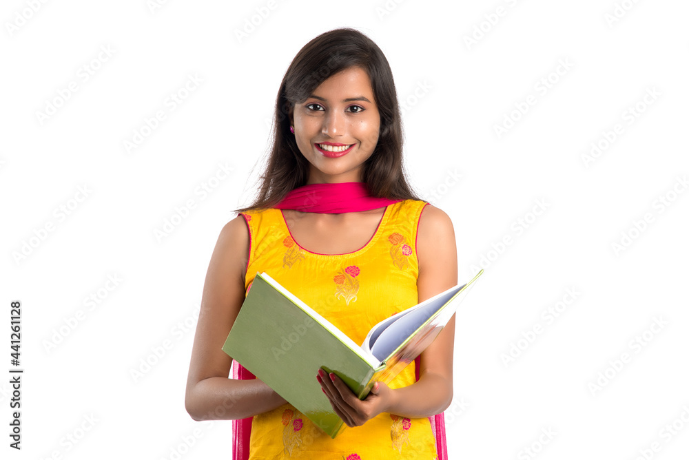 Pretty young girl holding book and posing on white background Pretty young girl holding book and posing on white background