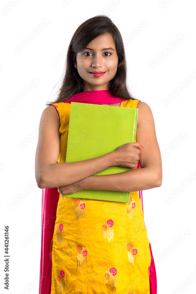 Pretty young girl holding book and posing on white background Pretty young girl holding book and posing on white background