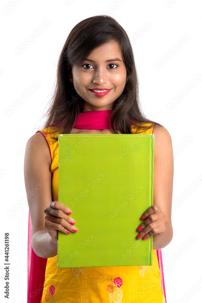Pretty young girl holding book and posing on white background Pretty young girl holding book and posing on white background