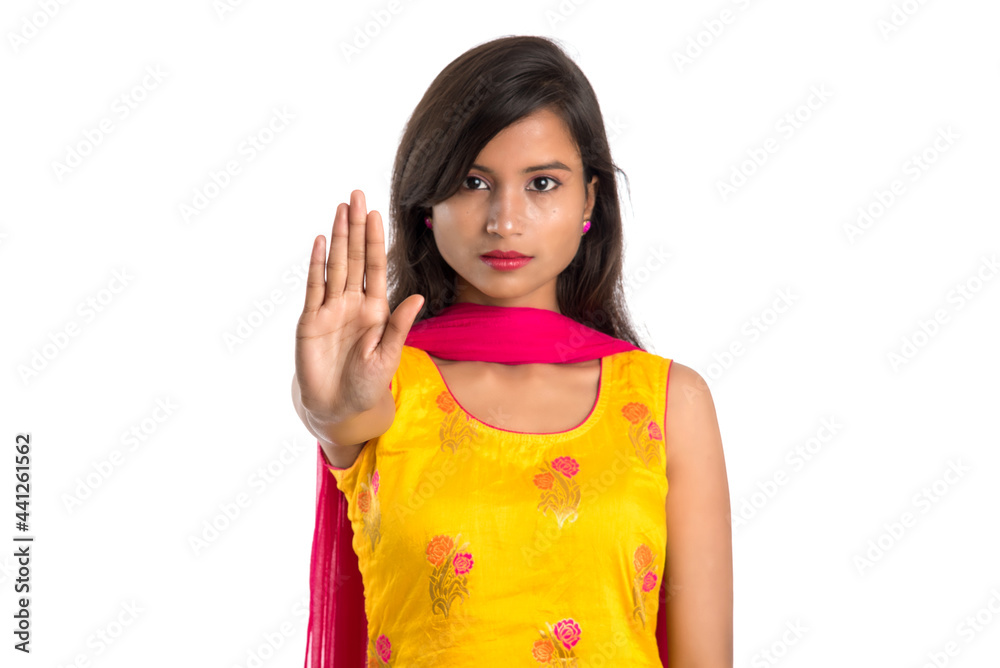 Portrait of a beautiful girl showing stop sign with palms isolated on a white background Portrait of a beautiful girl showing stop sign with palms isolated on a white background