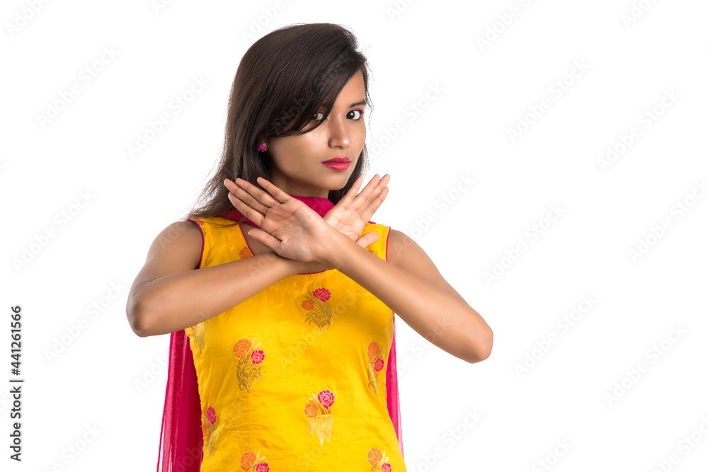 Portrait of a beautiful girl showing stop sign with palms isolated on a white background Portrait of a beautiful girl showing stop sign with palms isolated on a white background