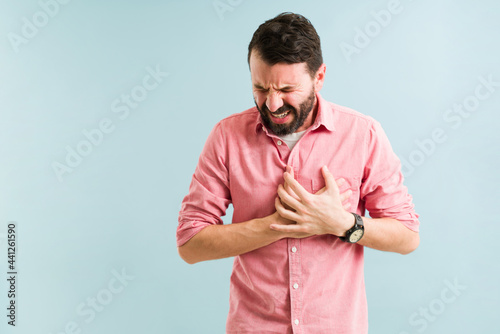 Sick man suffering from coronary issues photo