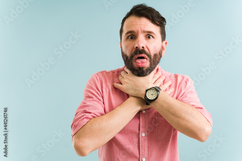 Latin man choking with a piece of food
