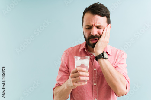 Attractive man with pain in his mouth photo