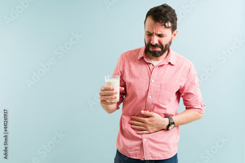 Adult man feeling bloated and with indigestion photo