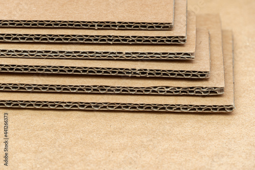 Obraz na plátně Stack of cardboard for packaging with cells close up as background