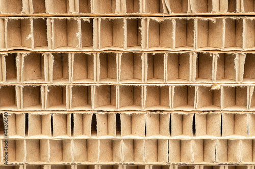 cut of honeycomb cardboard pack stack with large cells close-up as a background