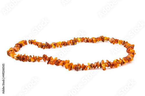 Baltic necklace made of Natural polished transparent honey luxury amber beads with inclusions on white. close up selective soft focus. Space for text