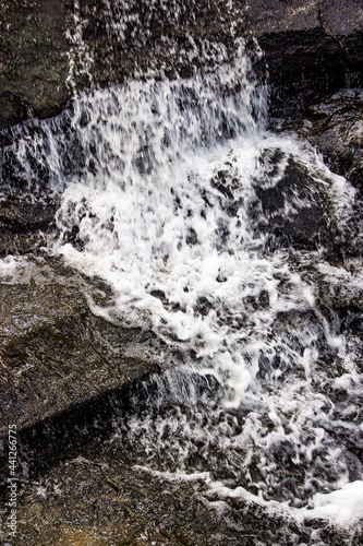 water flowing over rocks © Somkid
