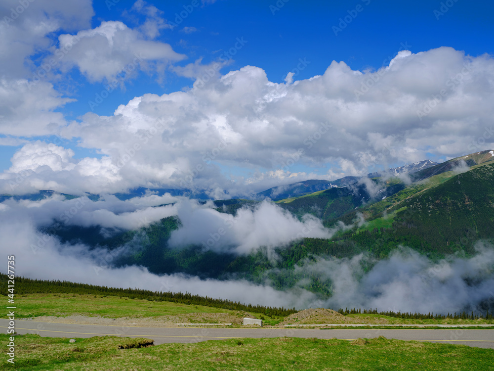 Beautiful scenic view in a rainy and cloudy day over the Transalpina road, the highest mountain road in the Carpathians located in the Parang mountains, Romania, Europe
