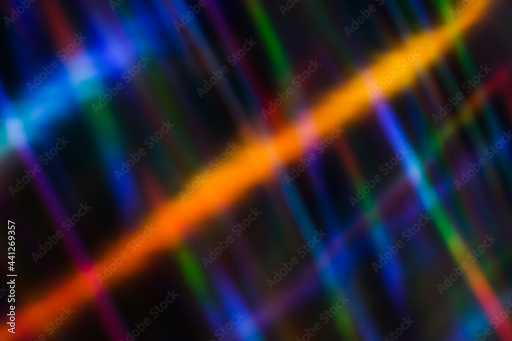 Neon rainbow strips on dark background. Soft focus Abstract rainbow color wave strips horizontal background