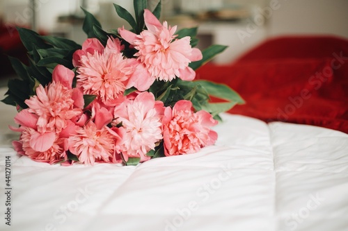 pink peonies in bed. romantic jesture -morning flowers in bed with room for text