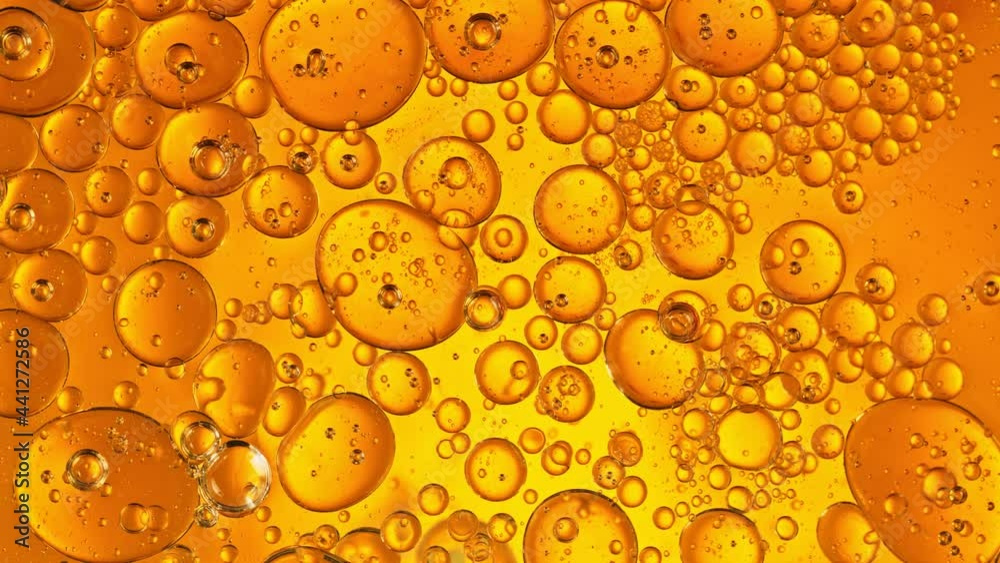 Super Slow Motion Shot of Moving Oil Bubbles on Golden Background at 1000fps. Super Slow Motion Shot of Moving Oil Bubbles on Golden Background at 1000fps.