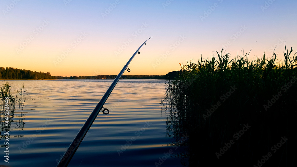 fishing rod on the background of a beautiful sunset sky fishing rod on the background of a beautiful sunset sky