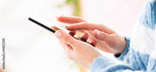 Female hands using mobile phone