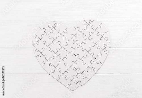 Bold heart shaped puzzle on white table photo