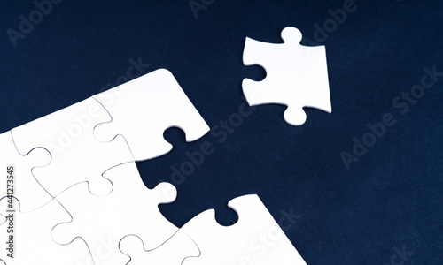 White jigsaw puzzle piece out of place photo