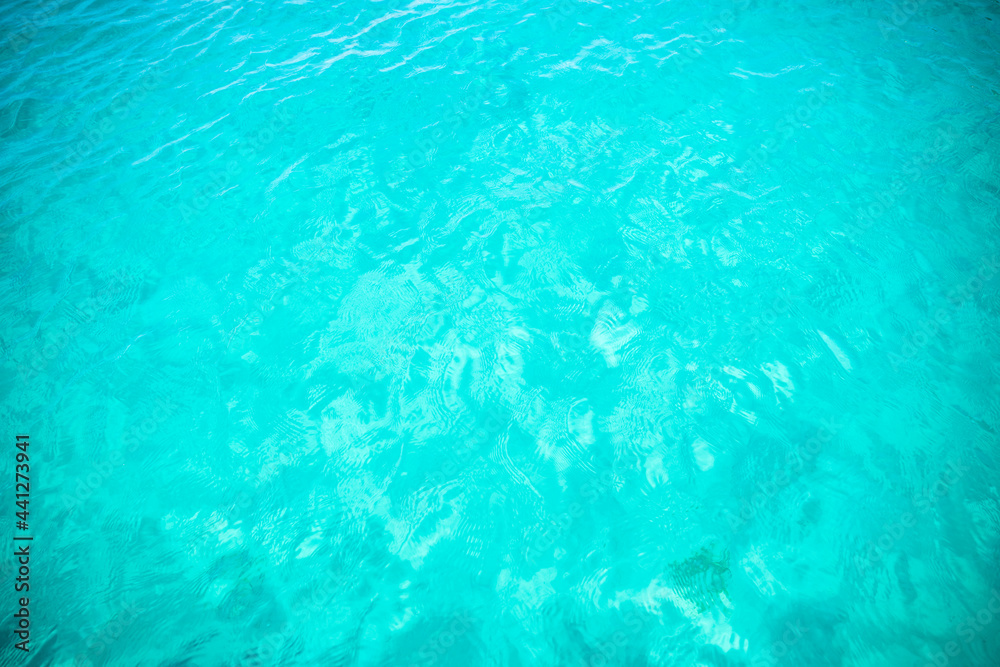Close-up view of a transparent turquoise sea water forming a natural background, Costa Smeralda, Sardinia, Italy. Natural pattern with copy space.