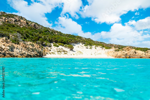 (Selective focus) Stunning view of a white sand beach bathed by a beautiful turquoise sea during a sunny day. Isola di Spargi, Maddalena Archipelago, Sardinia, Italy. © Travel Wild