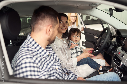 The young family chooses their first car.