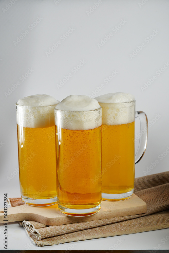 two Glasses of light beer with decorations and place for text two Glasses of light beer with decorations and place for text