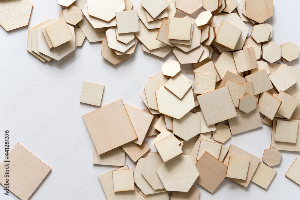 piles of wooden shapes on white