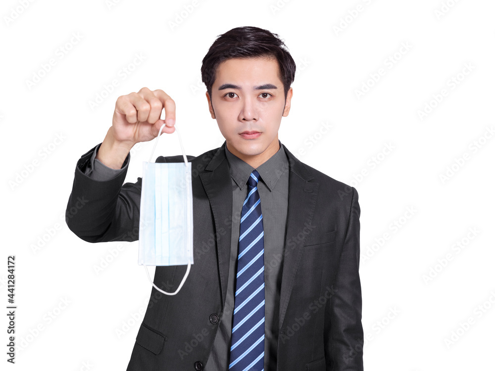 young businessman holding a medical mask. During the covid-19 epidemic, he should always wear the mask by his side young businessman holding a medical mask. During the covid-19 epidemic, he should always wear the mask by his side