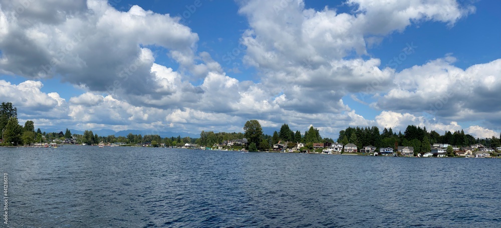 Lake Stevens, Washington state on a sunny summer day with some clouds in a blue sky. Lake Stevens, Washington state on a sunny summer day with some clouds in a blue sky.