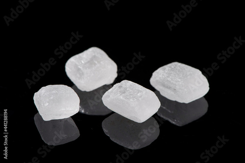 white rock candy sugar isolated on black background