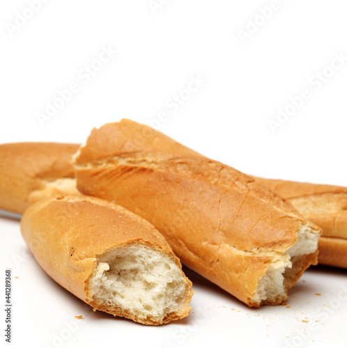 crusty mini baguettes on white background
