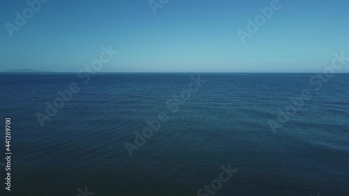 Wallpaper Mural Tuscany Italy drone sandy beach at the seaside near Alberese in the iconic Maremma nature park by sunset. Cinematic aerial footage flying over the ocean sea, waves and driftwood by sunset. Torontodigital.ca