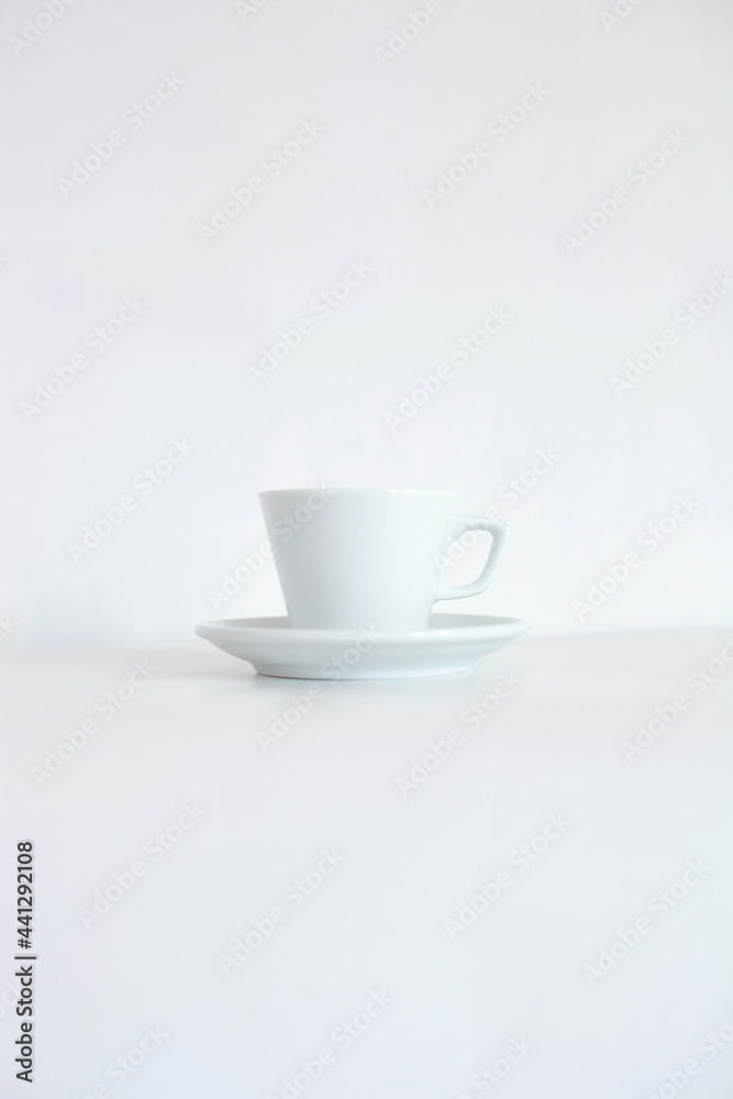 White cup with tray isolated on white background White cup with tray isolated on white background