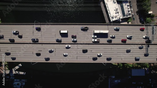 Drone Overhead Cars Commuting Across Bridge Over Blue Water photo