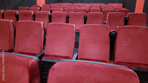 Red chairs in the cinema hall before the start of the session.