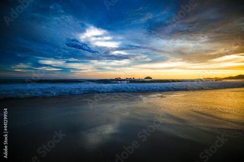 landscape with sea sunset on beach  clouds  sun and island. Beautiful sunrise over the sea  people walking Panorama of Beach  Ocean  People