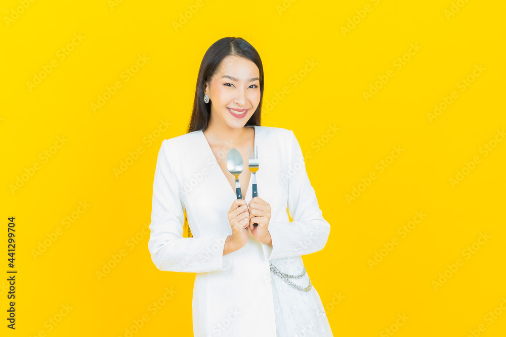 Portrait beautiful young asian woman smile with spoon and fork Portrait beautiful young asian woman smile with spoon and fork