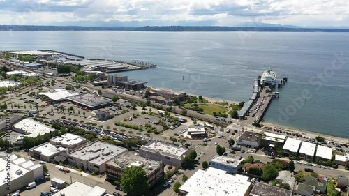 Cinematic 4K drone trucking footage of the downtown Edmonds commercial area, Kingston ferry terminal, Port of Edmonds, waterfront marina, near Seattle, Washington, in Snohomish County photo