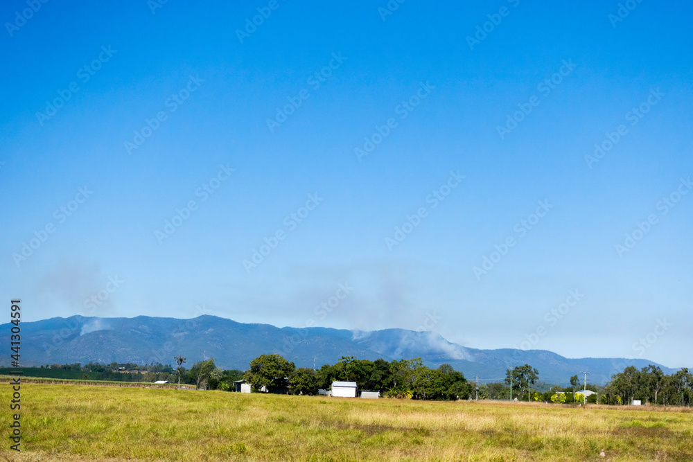 Smoke in the forest covered hills on the Atherton Tableland in Queensland, Australia