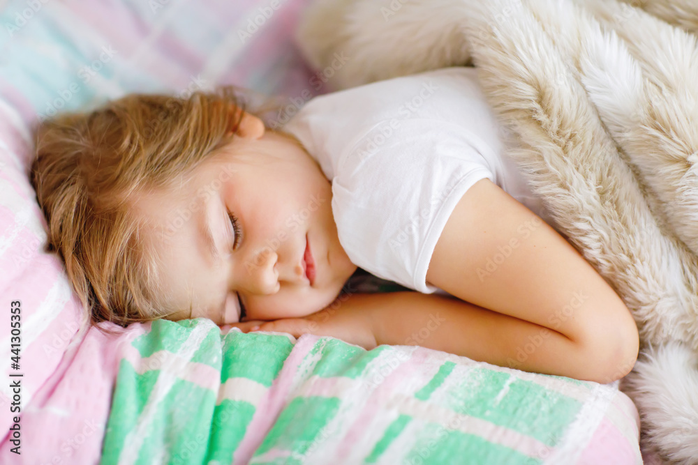 Cute little toddler girl sleeping in bed. Tired preschool child dreaming, healthy sleep of children by day. Cute little toddler girl sleeping in bed. Tired preschool child dreaming, healthy sleep of children by day.