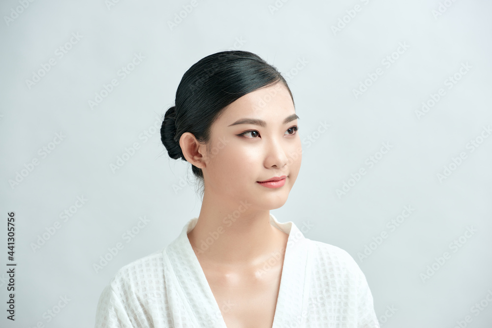 Youthful bright skin pretty Asian woman with hand touching face on white background for beauty concepts Youthful bright skin pretty Asian woman with hand touching face on white background for beauty concepts