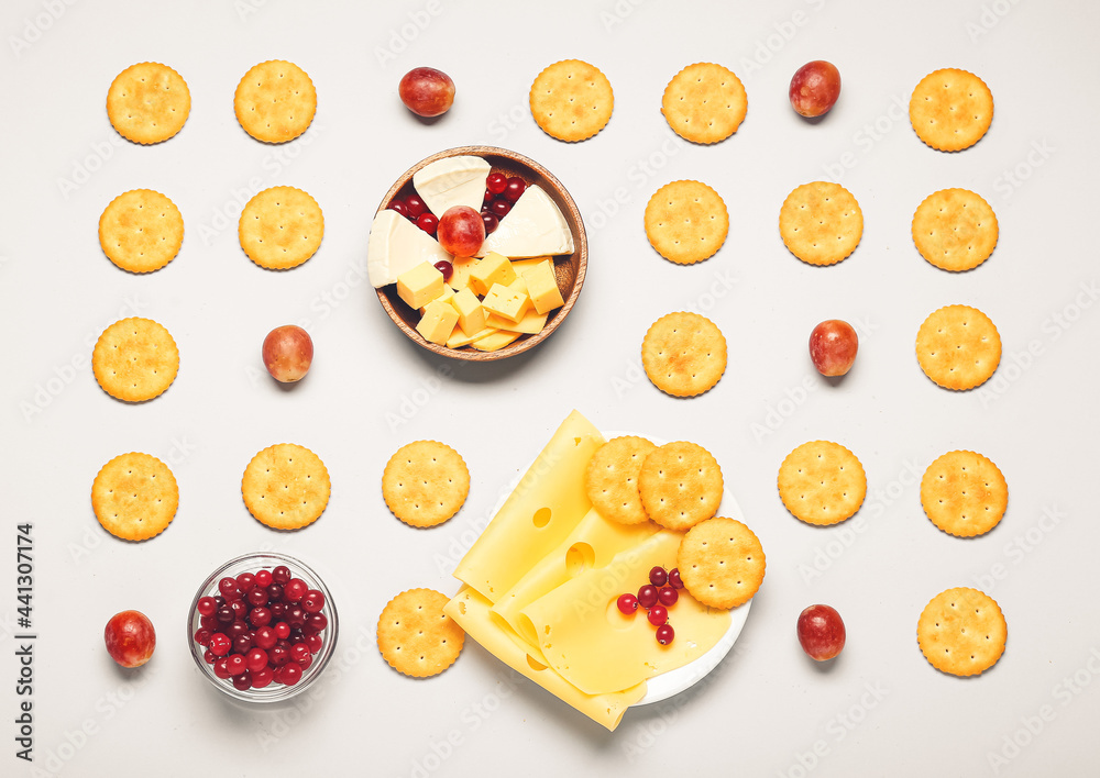 Tasty crackers and snacks on white background