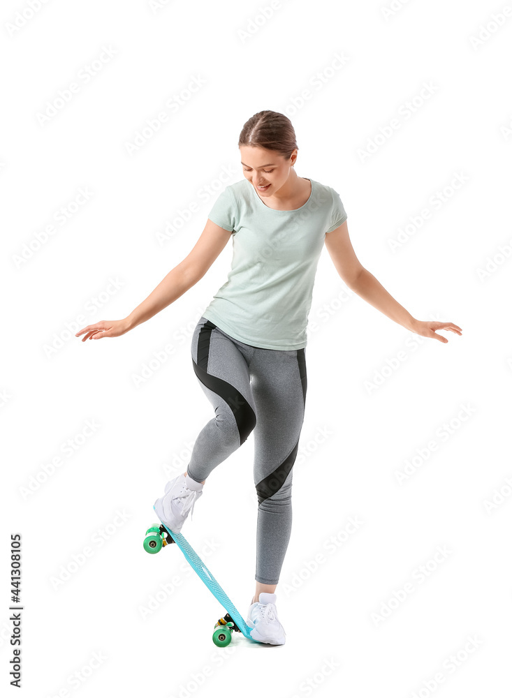 Sporty young woman with skateboard on white background