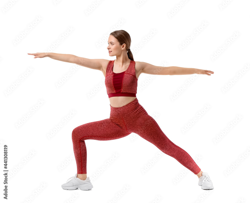 Sporty young woman doing yoga on white background