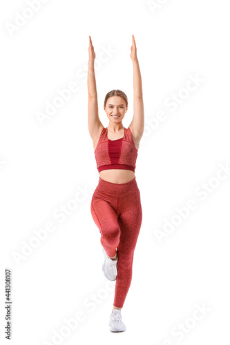 Sporty young woman doing yoga on white background