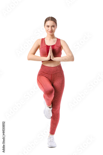 Sporty young woman doing yo...