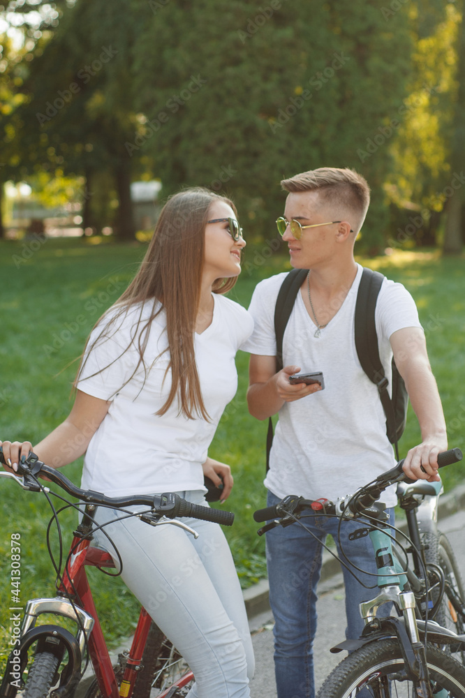 Couple riding bikes in summer forest